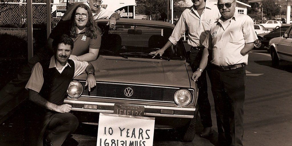 A group of people gathered around a car