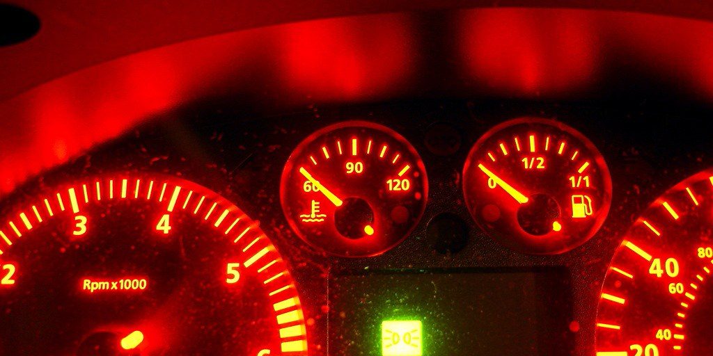 A car instrument cluster glowing at night